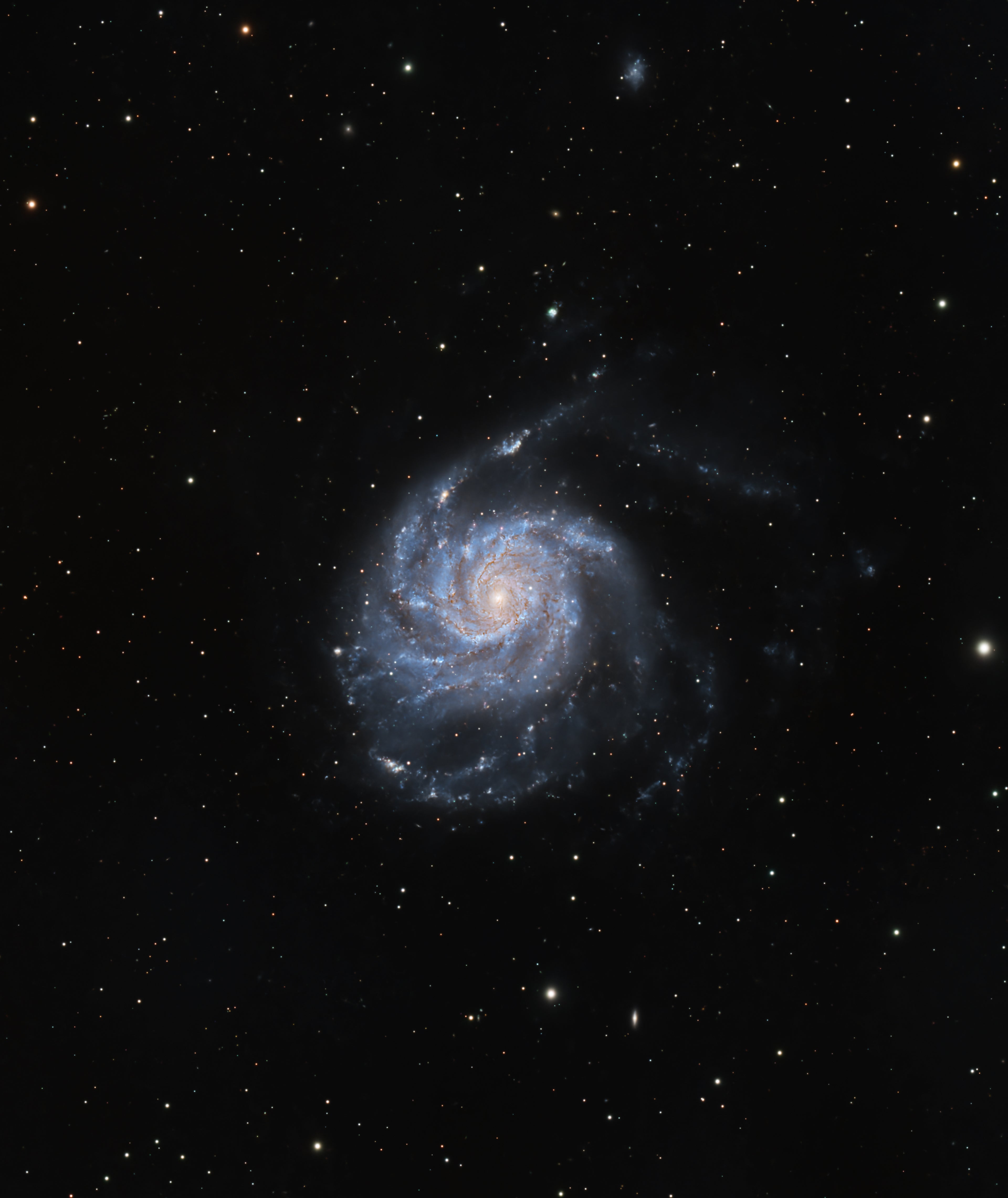 A deep-space astrophotography image of a spiral galaxy, showing a bright blue and white galactic core surrounded by dark blue and white spiral arms, set against a black starry sky.