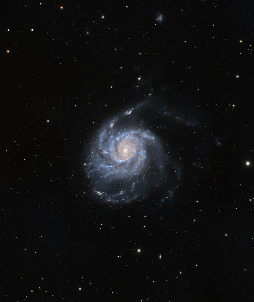 A deep-space astrophotography image of a spiral galaxy, showing a bright blue and white galactic core surrounded by dark blue and white spiral arms, set against a black starry sky.